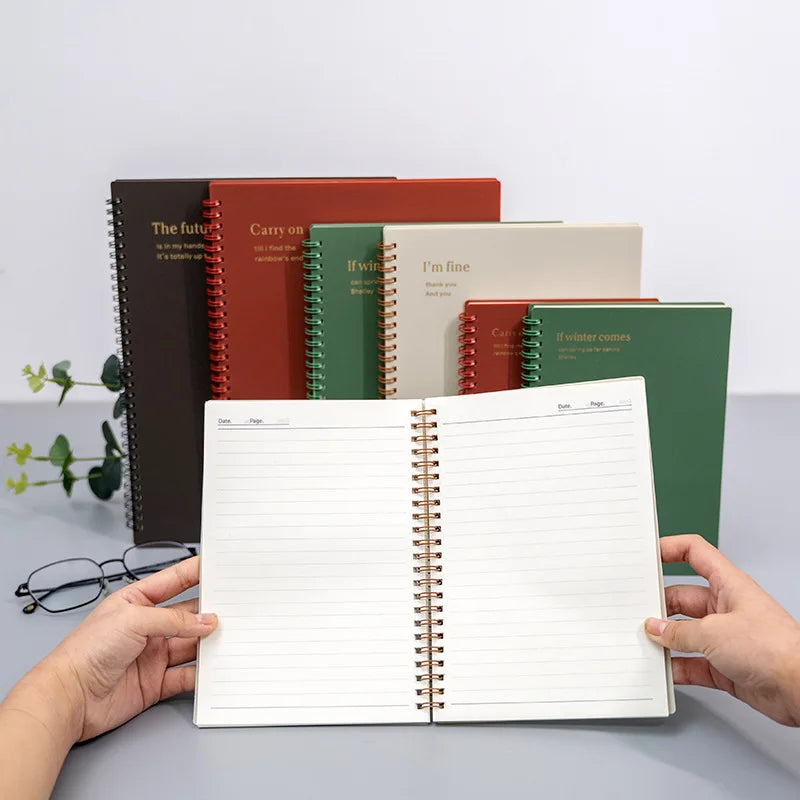 An open spiral notebook displaying its lined pages, ready for writing notes or sketches.