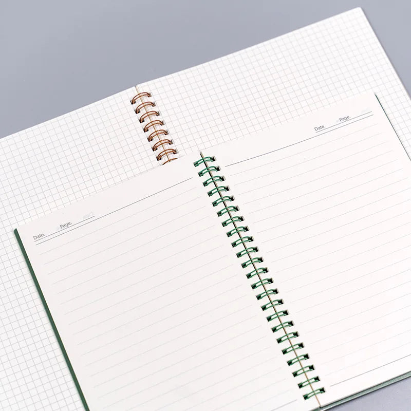 An opened spiral notebook with lined pages placed next to an open square graph notebook, highlighting the differences between lined and graph paper formats.